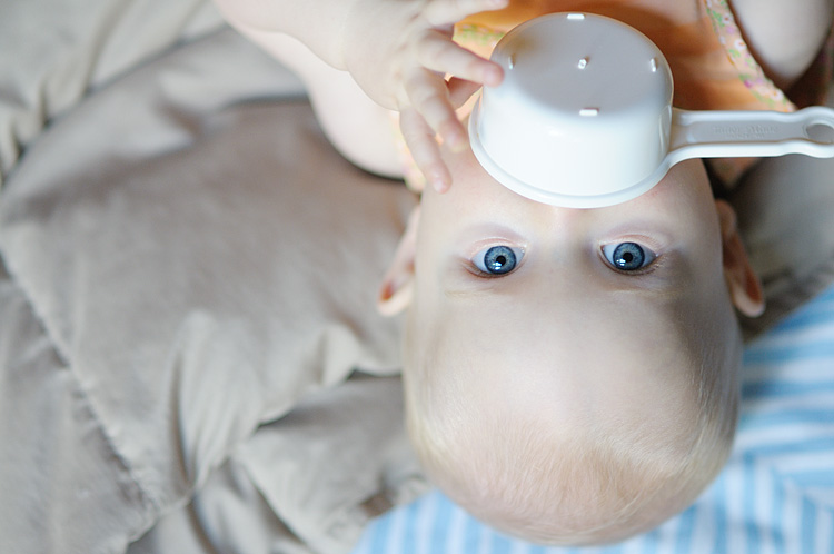 Baby with measuring cup photo